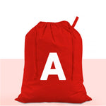 Red drawstring bag with a white letter 'A' on a light pink background
